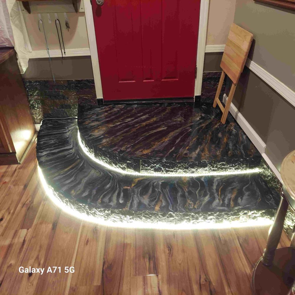 Custom finished entry steps with LED accent lighting beside a red front door