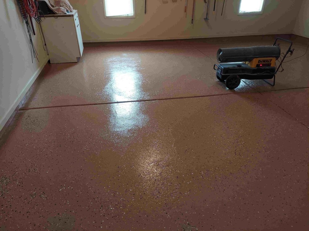 Freshly coated garage floor with a speckled finish